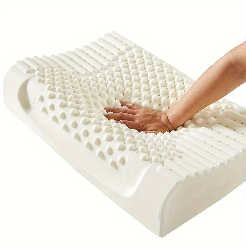 White foam pillow with hand pressing into it on a white background