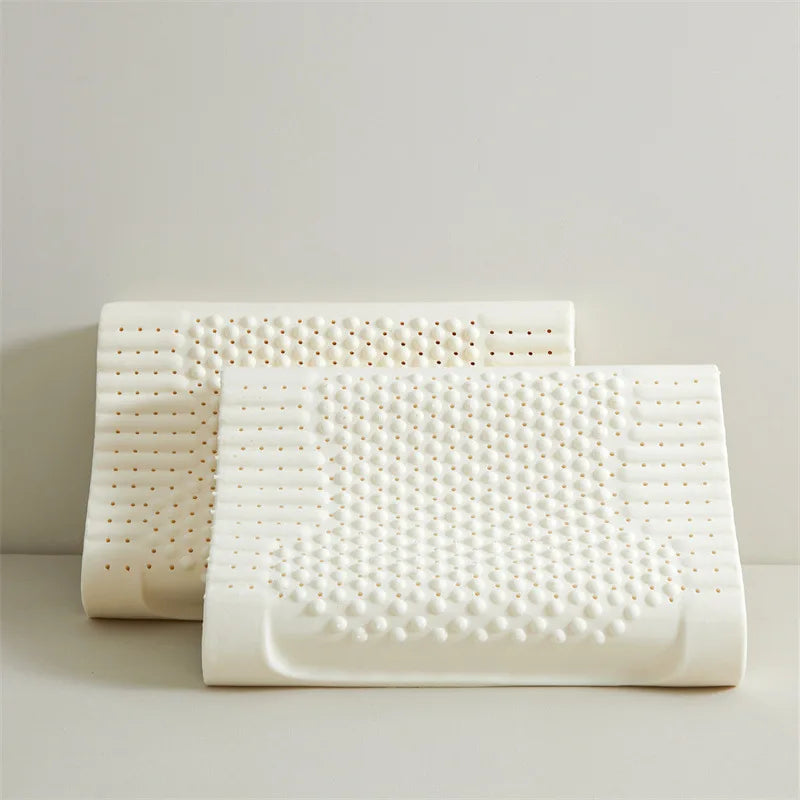 Two white pillows with a textured surface on a light gray background